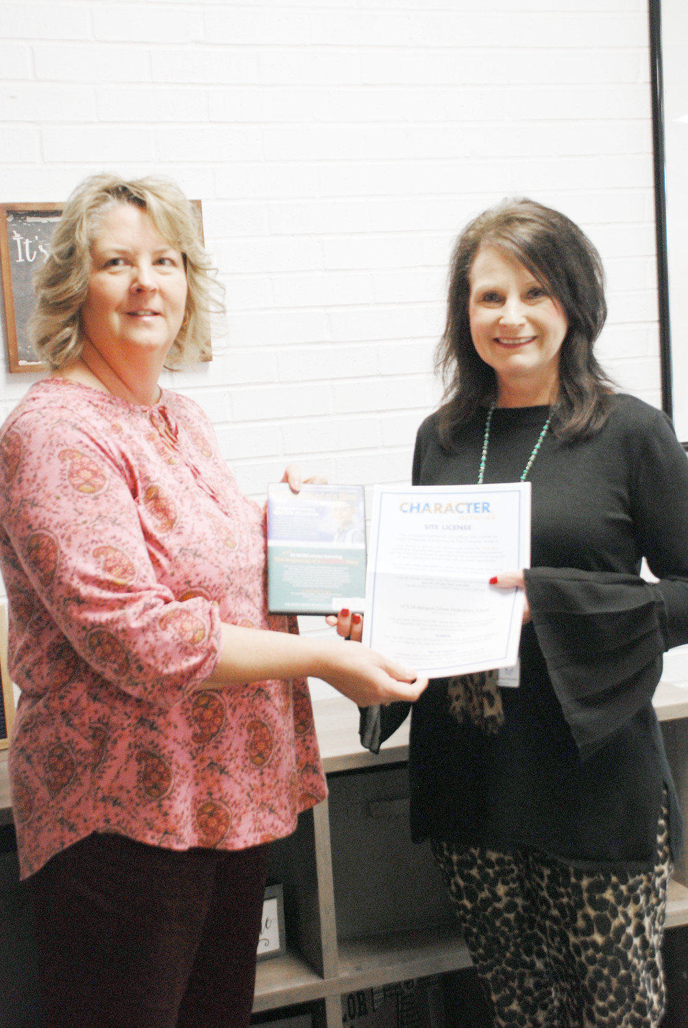 Susan Rogers from the Quitmann Pilot Club (left) presents The Beginning of a Hero anti-bulling program to Tracey Helfferich, Acting Superintendent of Yantis ISD and the Principal of Imogene Glenn Elementary School.