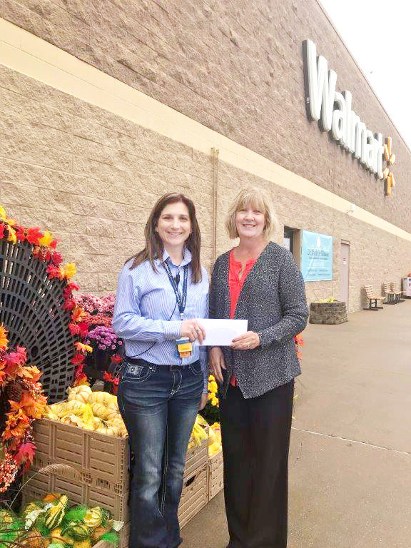 The Caring and Sharing team is excited to have received a $500 Walmart Community Grant. Caring and Sharing is a non-profit organization that has provided Christmas cheer for families in the Mineola ISD for over 30 years in the form of food and gifts. Carrie Mahon, co-manager for Walmart in Mineola, is pictured giving the check to Becky Moore, co-chair of Caring and Sharing.    