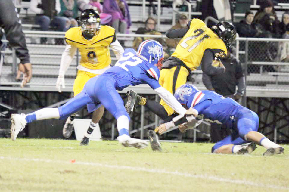 Quitman’s Gavin Oakes makes a stop with an unidentified Bulldog defender in Quitman’s home final against Winona. (Photo by Sheree Phillips)