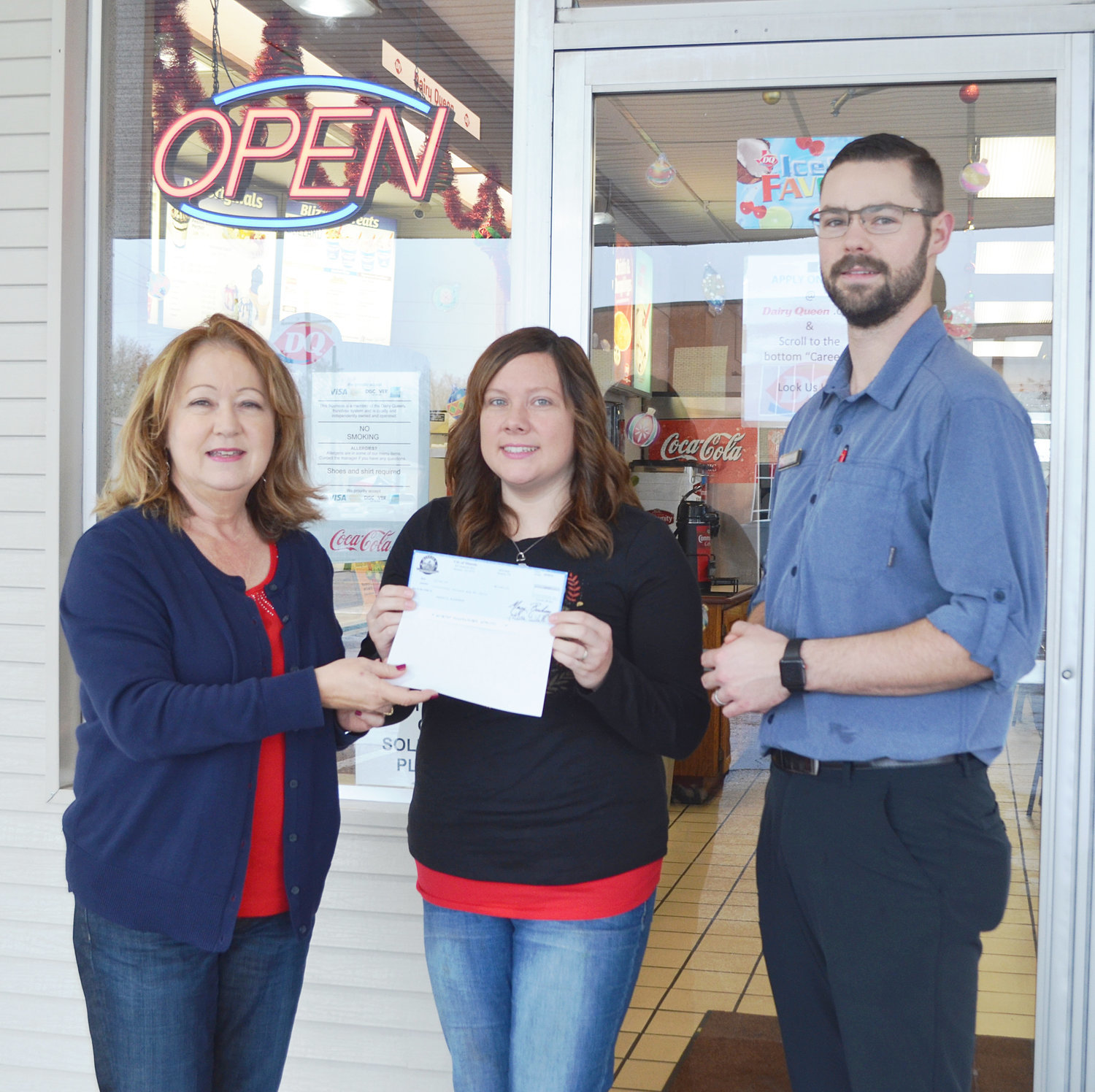 Rebecca Bohannan, center, was the winner of $500 from the Shop Local Mineola campaign. While shopping in downtown Mineola, she visited Dairy Queen and her receipt was the first one drawn as part of this year’s contest. Also pictured is Doris Newman, director of the Mineola Main Street program, and Dairy Queen owner Daniel Tucker. The campaign covers purchases made between Nov. 23 and Dec. 28.