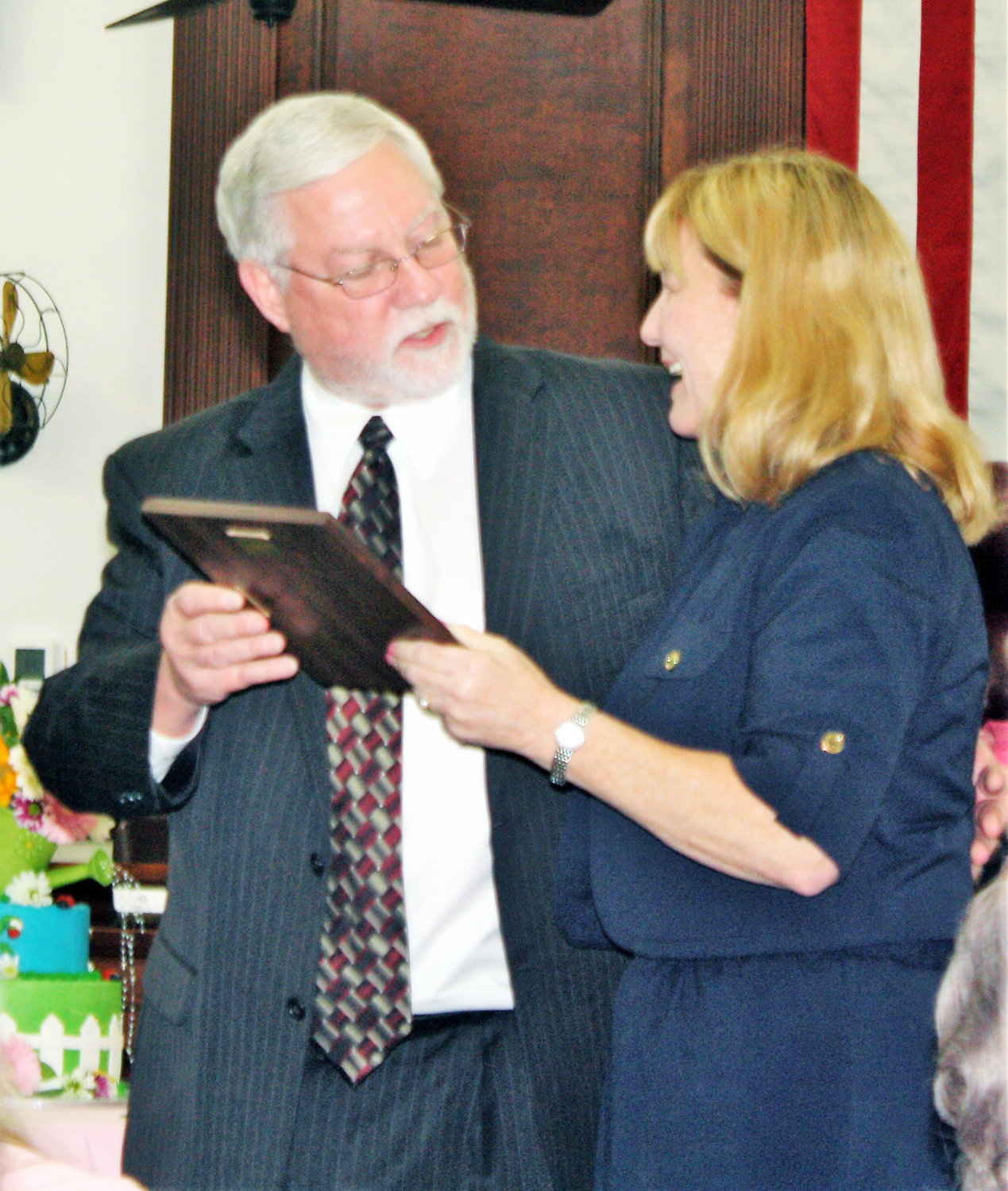 Wood County Judge Bryan Jeanes gives retiring Wood County District Clerk Jenica Turner her retirement plaque after 28 years of service to the county, including 15 years as district clerk.