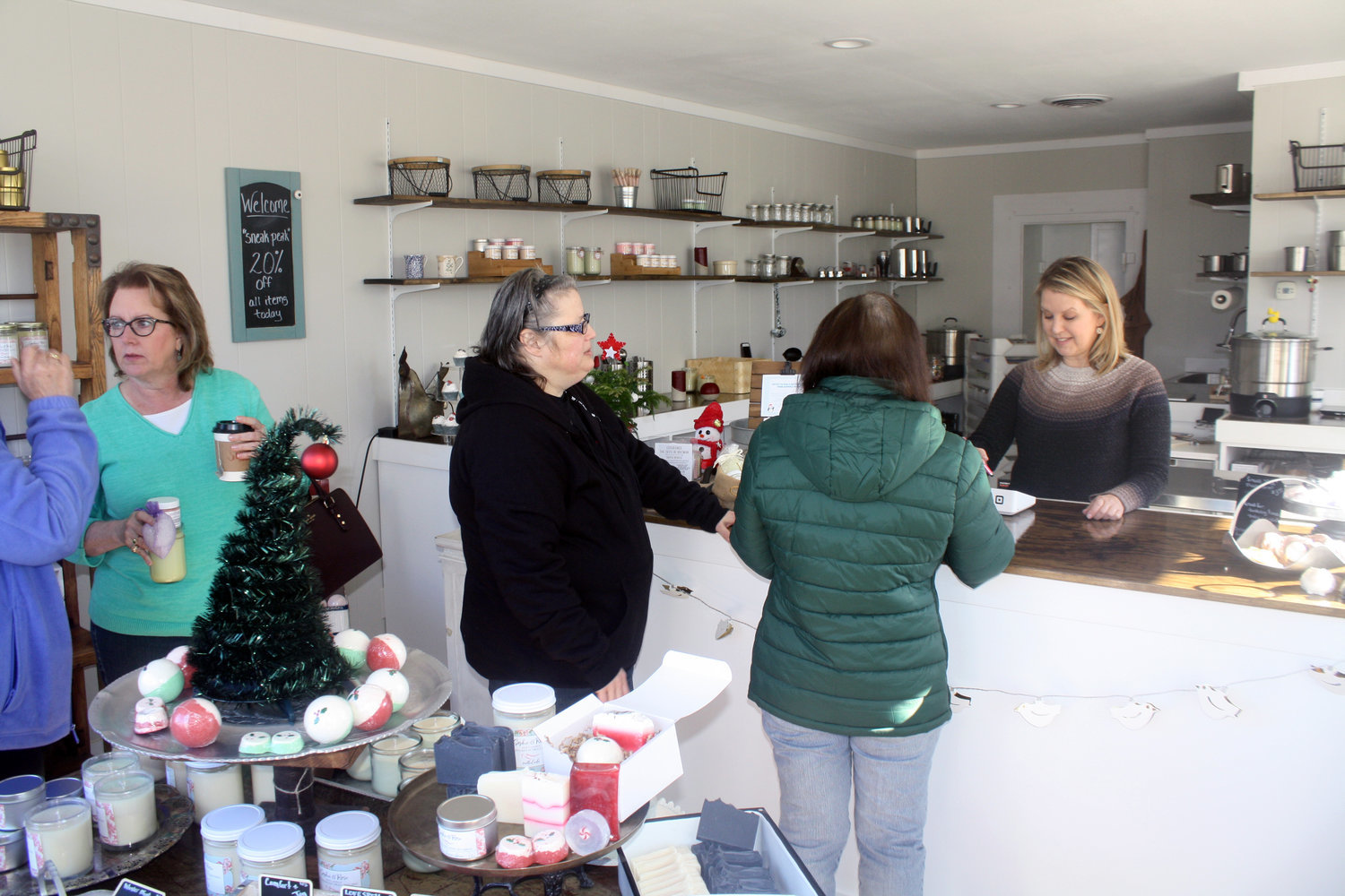 Customers shop at Sophie & Rose, the new handmade soap and candle shop in Quitman, during the soft opening event on Dec. 15.