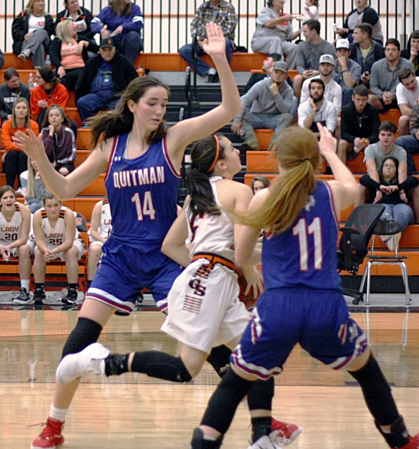 Lady Bulldogs Ava Burroughs and Shelby Hayes defend a drive against Grand Saline.