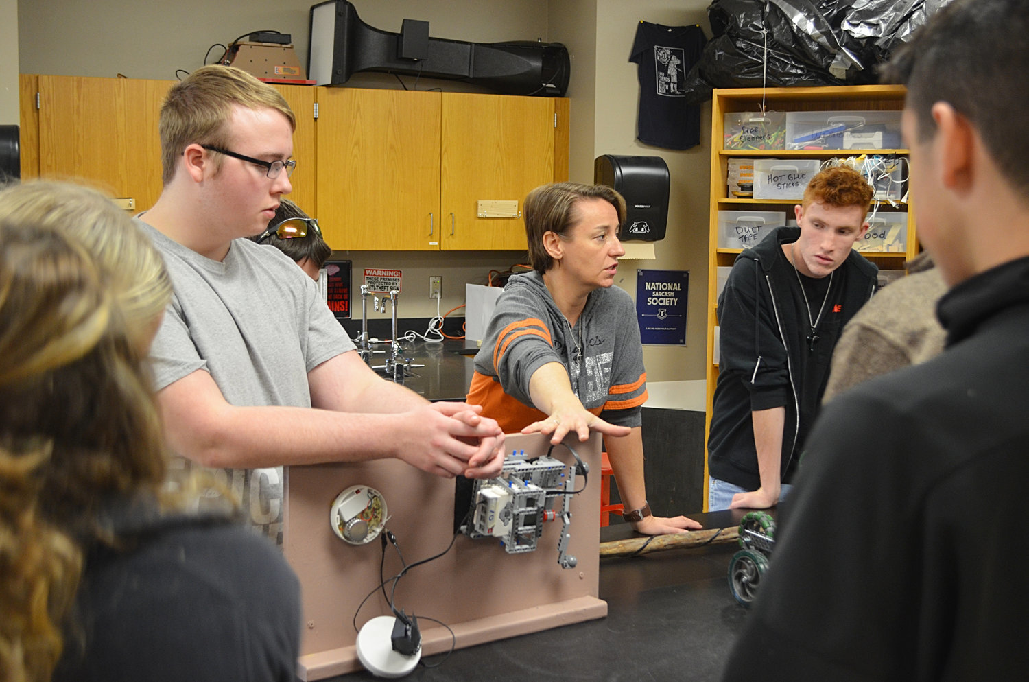 High school student Matthew Carder, left, teacher Deborah Armstrong, middle, and high school student Tanner Taylor tell eighth-graders about a project in a technology and engineering classroom.