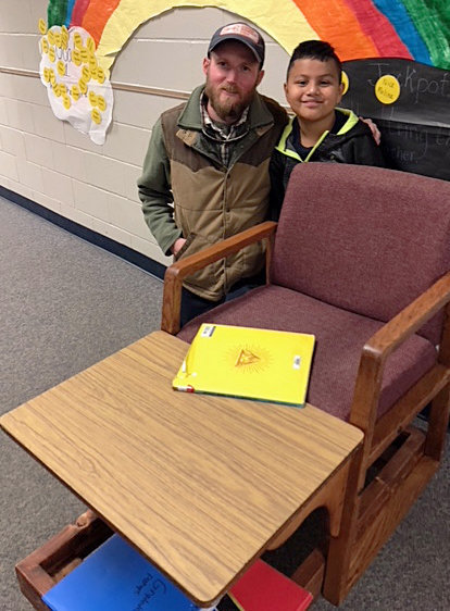 QISD maintenance worker Chris Williams and fourth-grader Angel Cortez with his mobile seat.