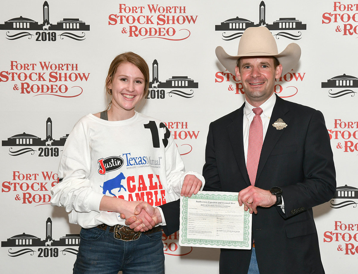 Jentri Jackson of the Quitman FFA receives her heifer purchase certificate after catching a calf at the 2019 Fort Worth Stock Show and Rodeo.