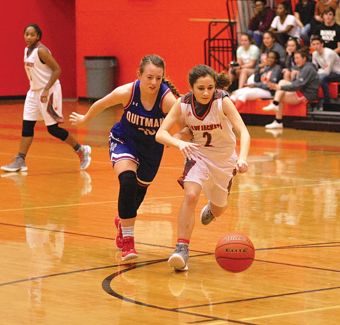 Lady Jacket Meghan Brewington chases down a loose ball in action against Quitman.
