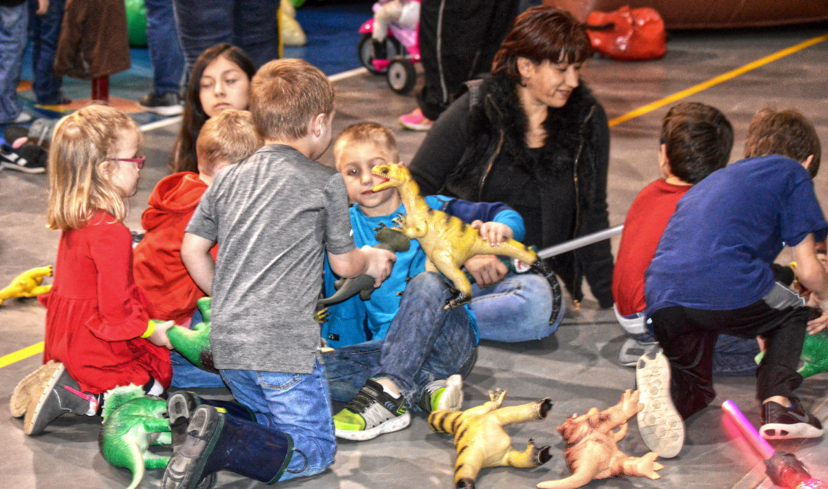 Students play with toy dinosaurs at the Quitman Elementary School dinosaur event on Feb. 7.