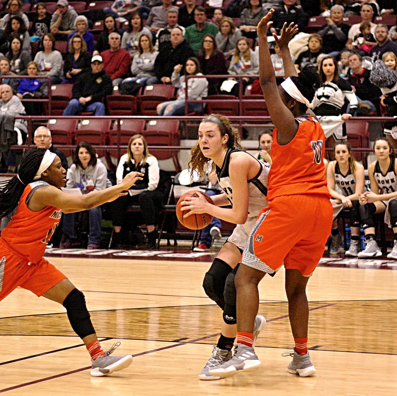 Tiara Stephens stops the ball while Jessiah Riley closes for a steal.