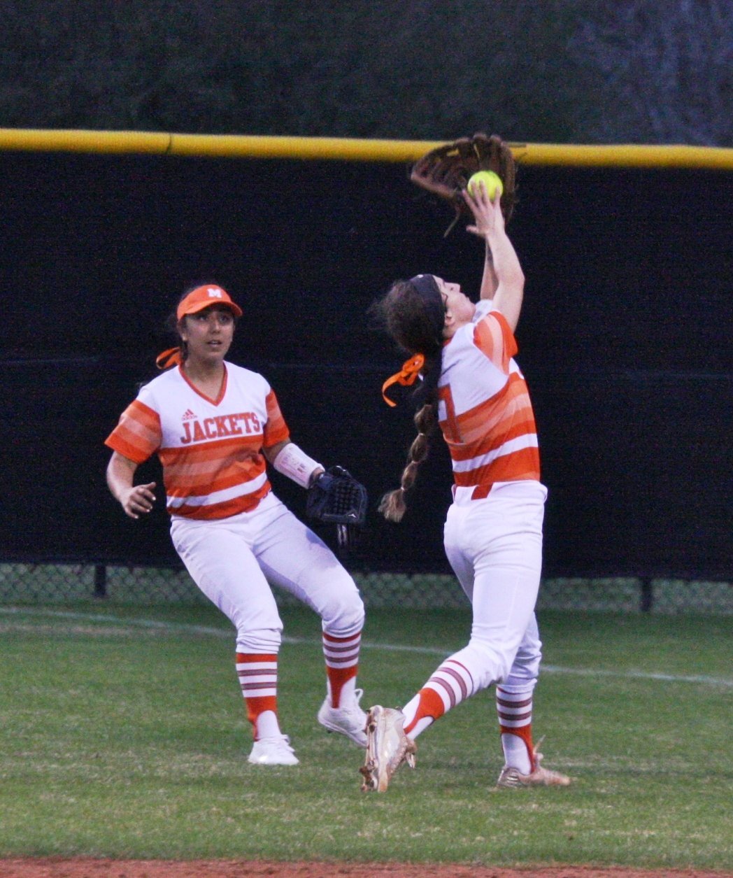 Lady Jacket second baseman Breanna Wilmoth makes an outstanding over-the-shoulder catch in action against Rains as right fielder Claudia Barriga looks on.