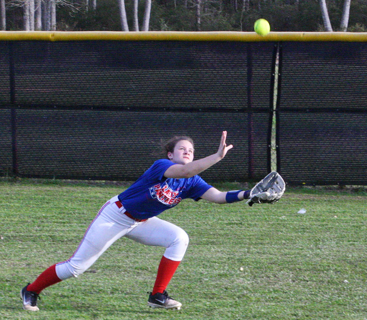 Lady Panther Rightfielder Laynie Culp closes for a difficult play down the line.