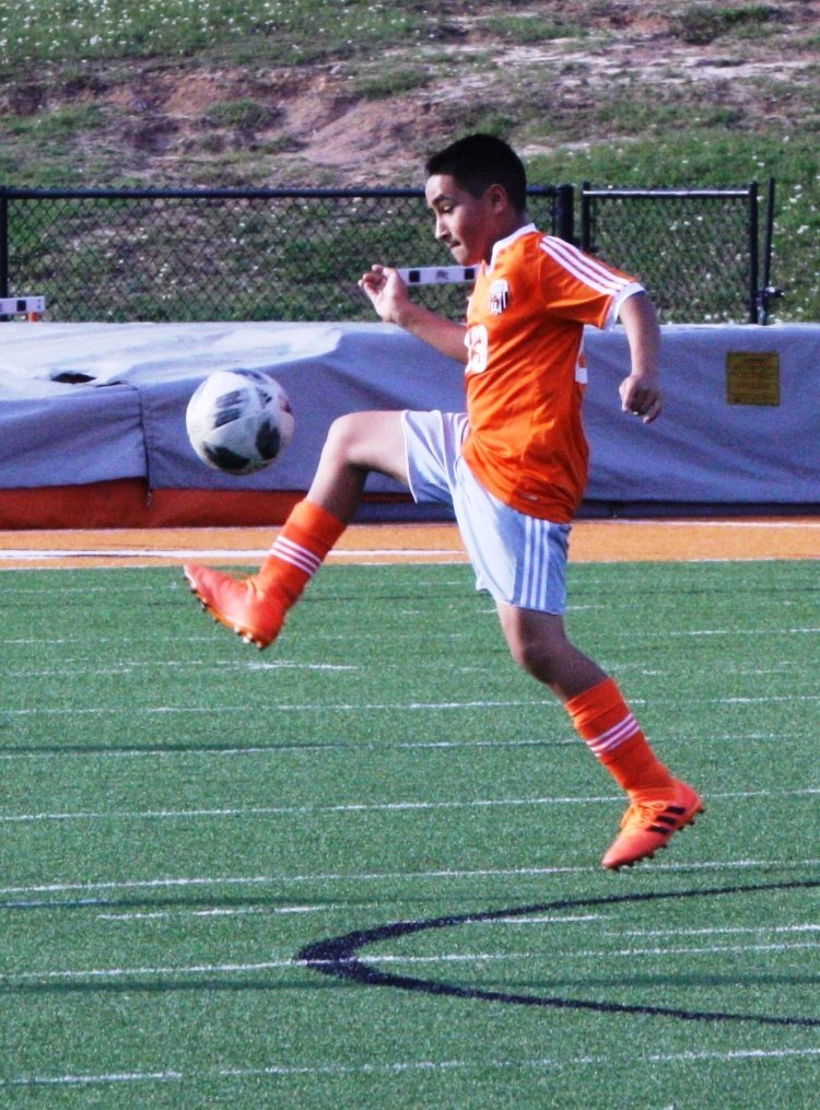Mineola junior varsity footballer Alexis Villeda works the ball during a recent match against Mabank.