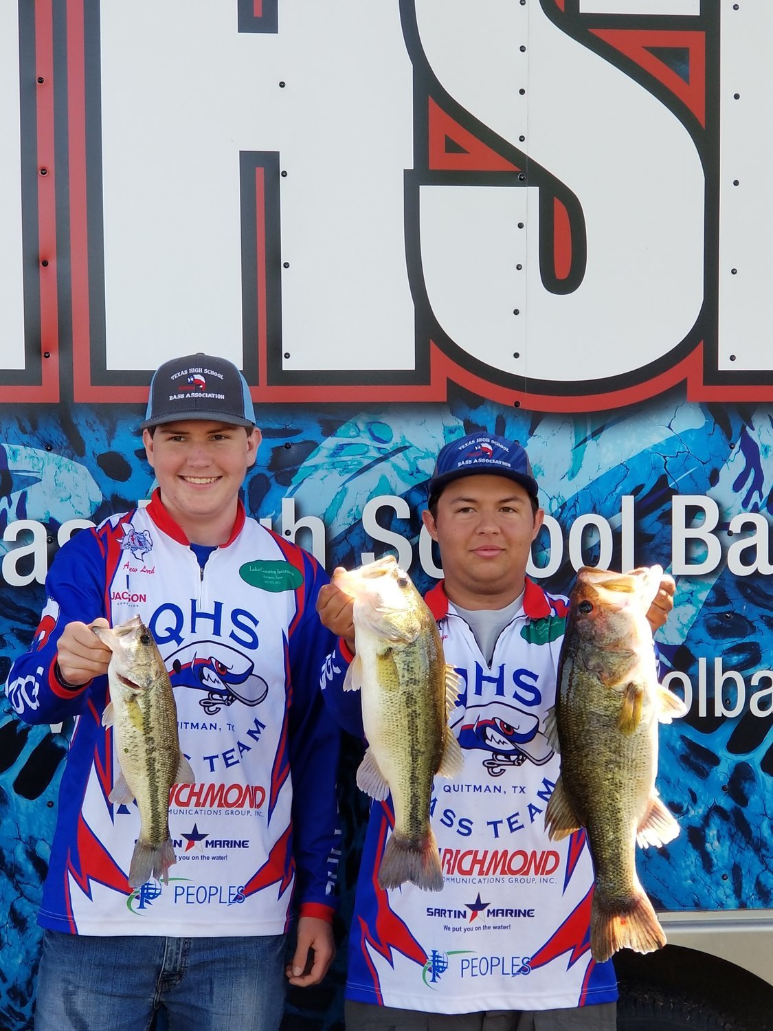 Sophomore Andrew Lord (left) and senior J.C. Brisendine with their catches that qualified them for the state fishing tournament.