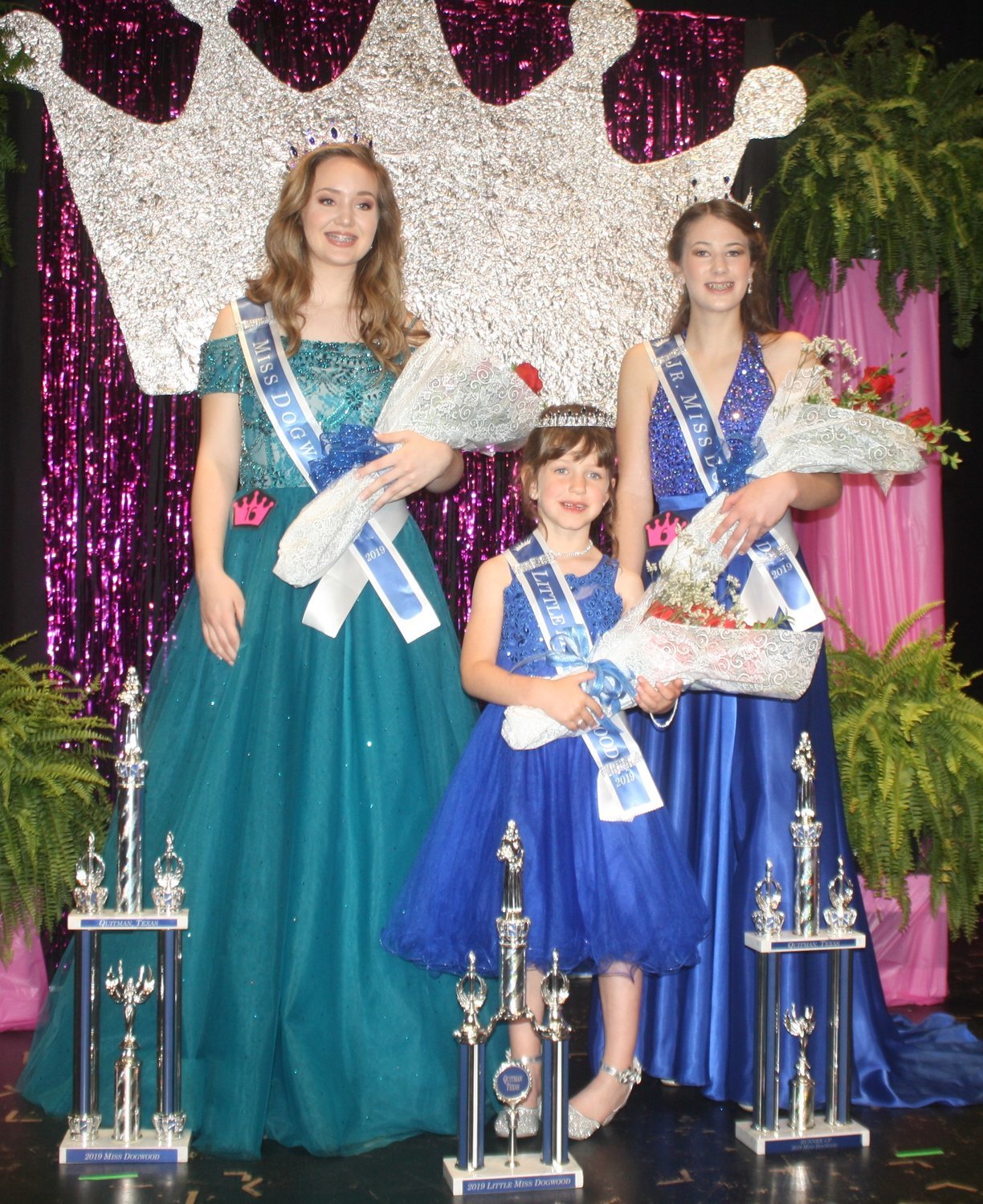 The 2019 Dogwood Queens together on stage with their flowers and trophies. Miss Dogwood Lucy Brannon (left) Little Miss Dogwood Karley Kernes (middle) and Junior Miss Dogwood Kameran Farnham.