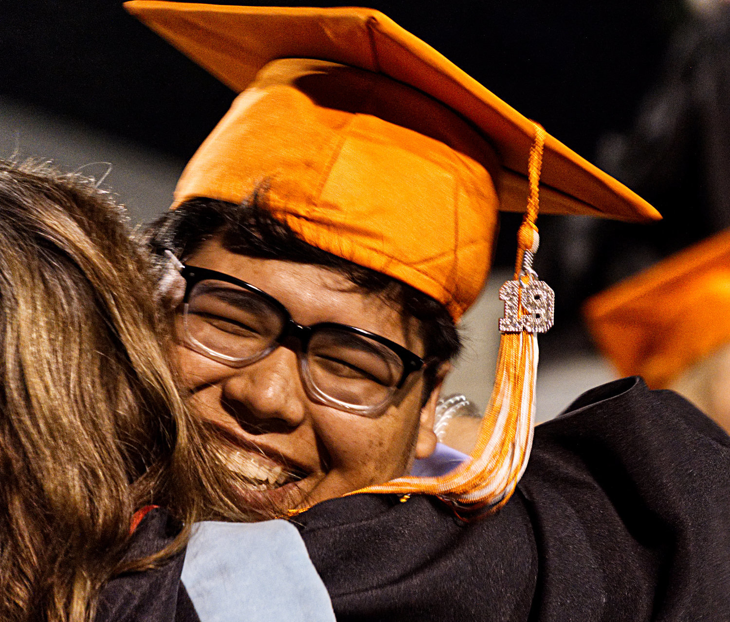 Armando Veloz gives one of his teachers a hug after receiving his diploma.