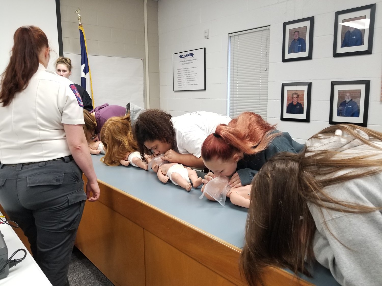 Quitman health science students practice CPR on infants.