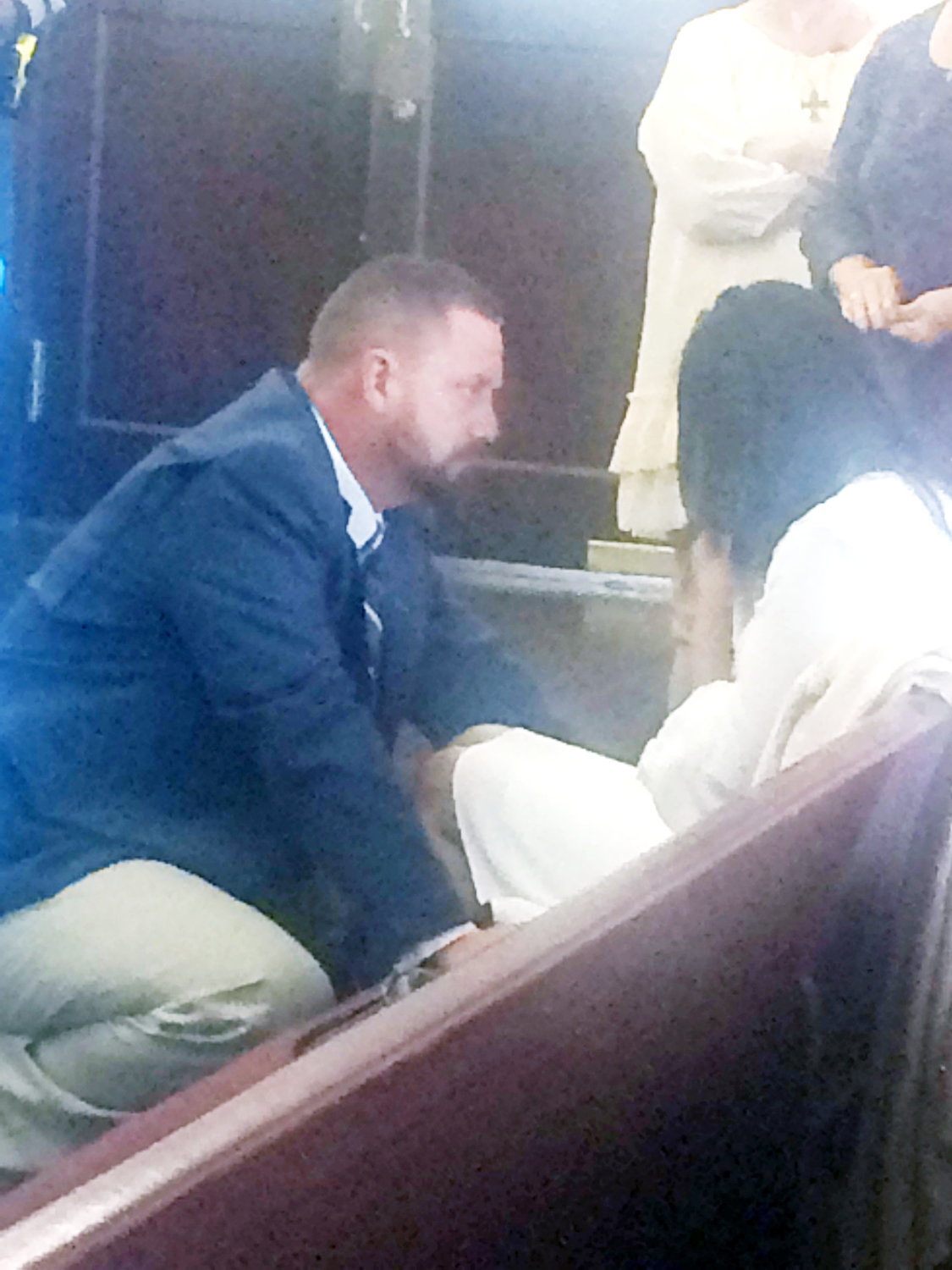 David McGee comforts his wife, Maya, after the jury found him guilty and before the punishment phase began during a recess during the trial.