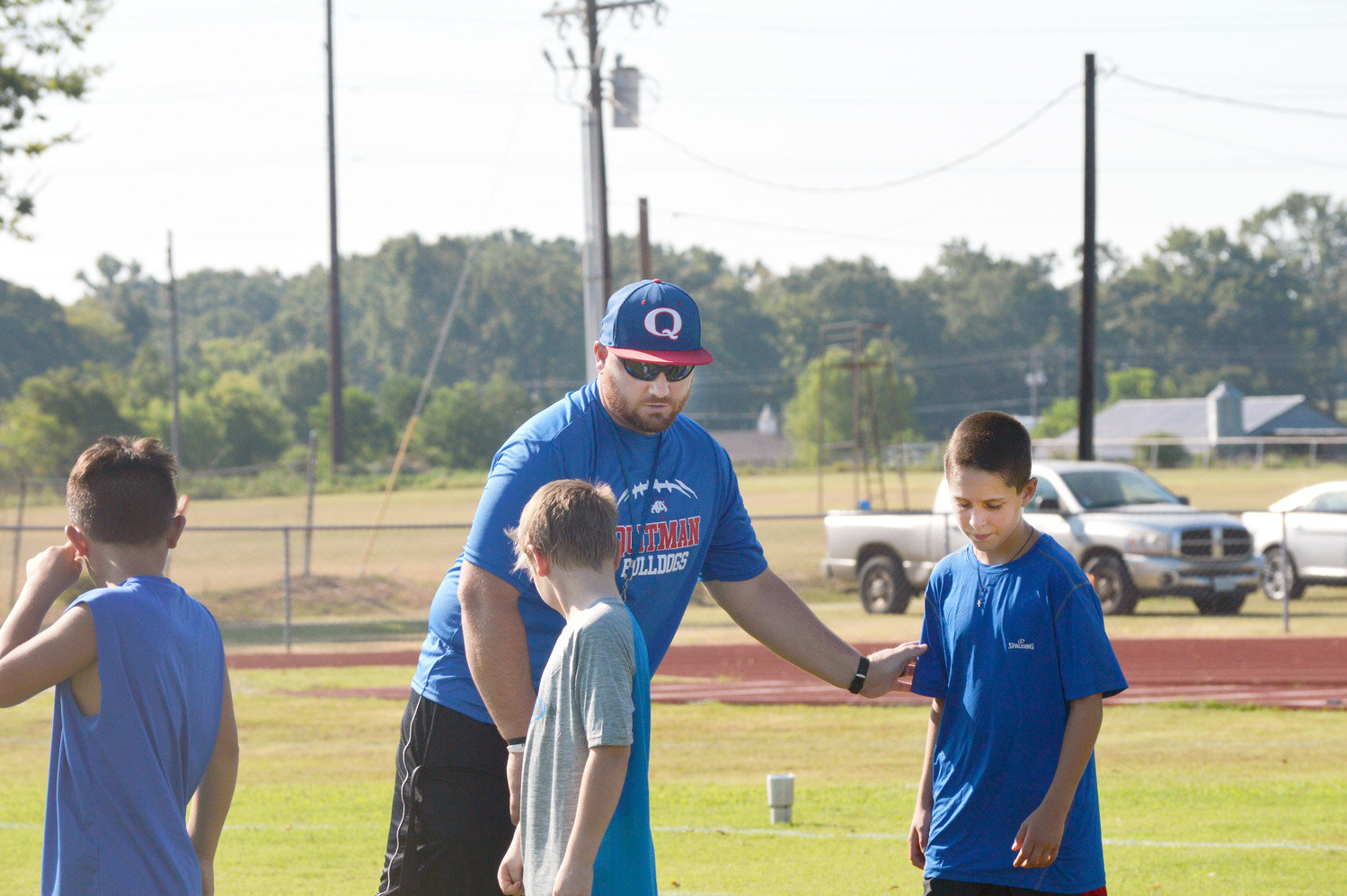 Quitman Coach Josh Wade instructs campers during Bulldog Football Camp last week.