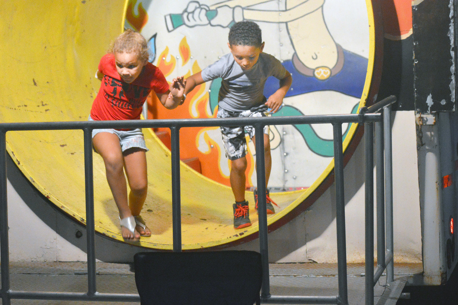 These two youngsters did their best to help each other through the tunnel at the end of the Fun House.