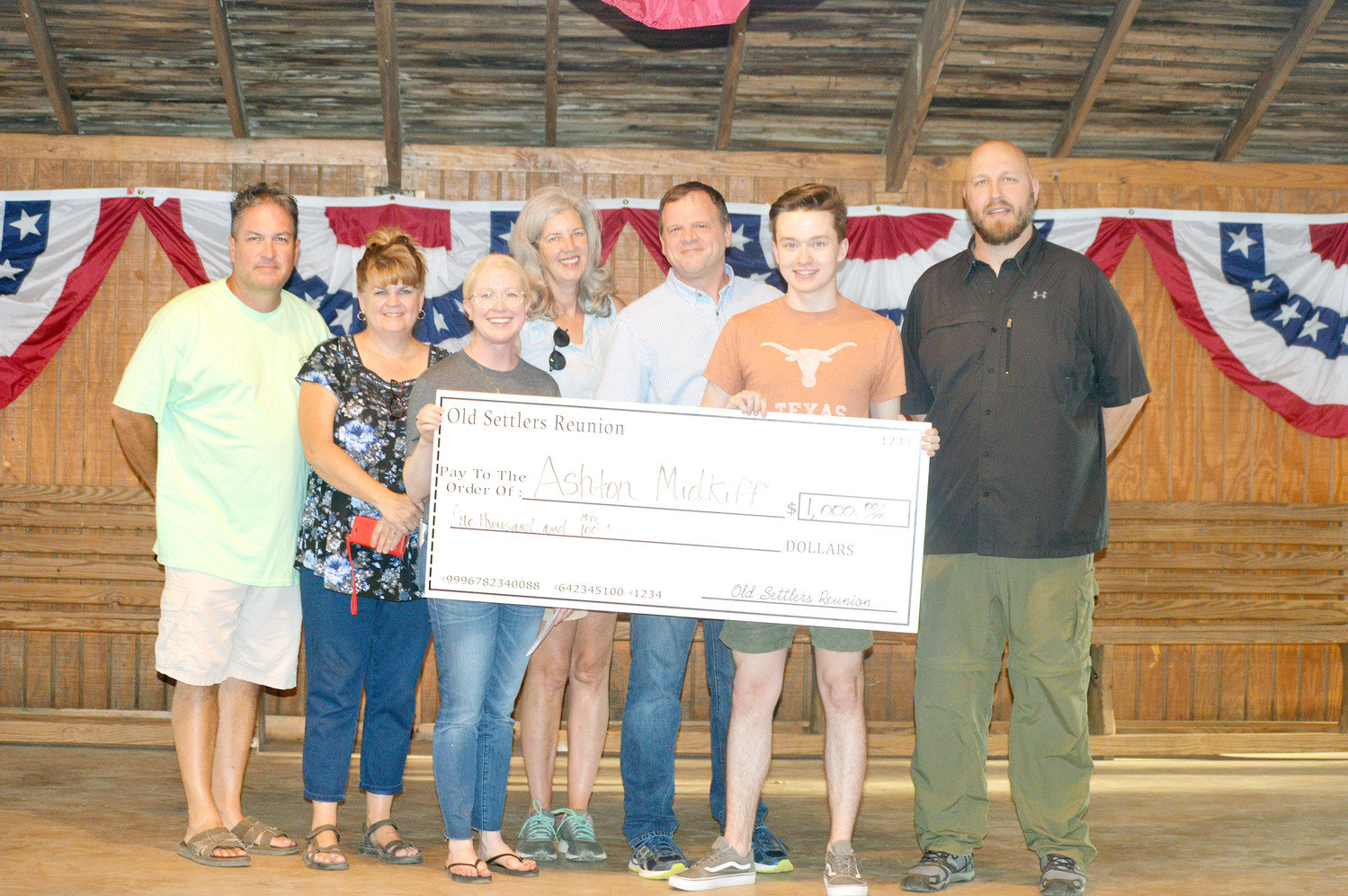 Quitman High School graduate Ashton Midkiff received a $1,000 scholarship from the Old Settlers Reunion Association which he will use this fall at the University of Texas. Pictured here are association board members Joe Wayne Reynolds, Laura Weems, Alice Bower, Julie Sandifer, Kevin Cameron, Midkiff and David French.
