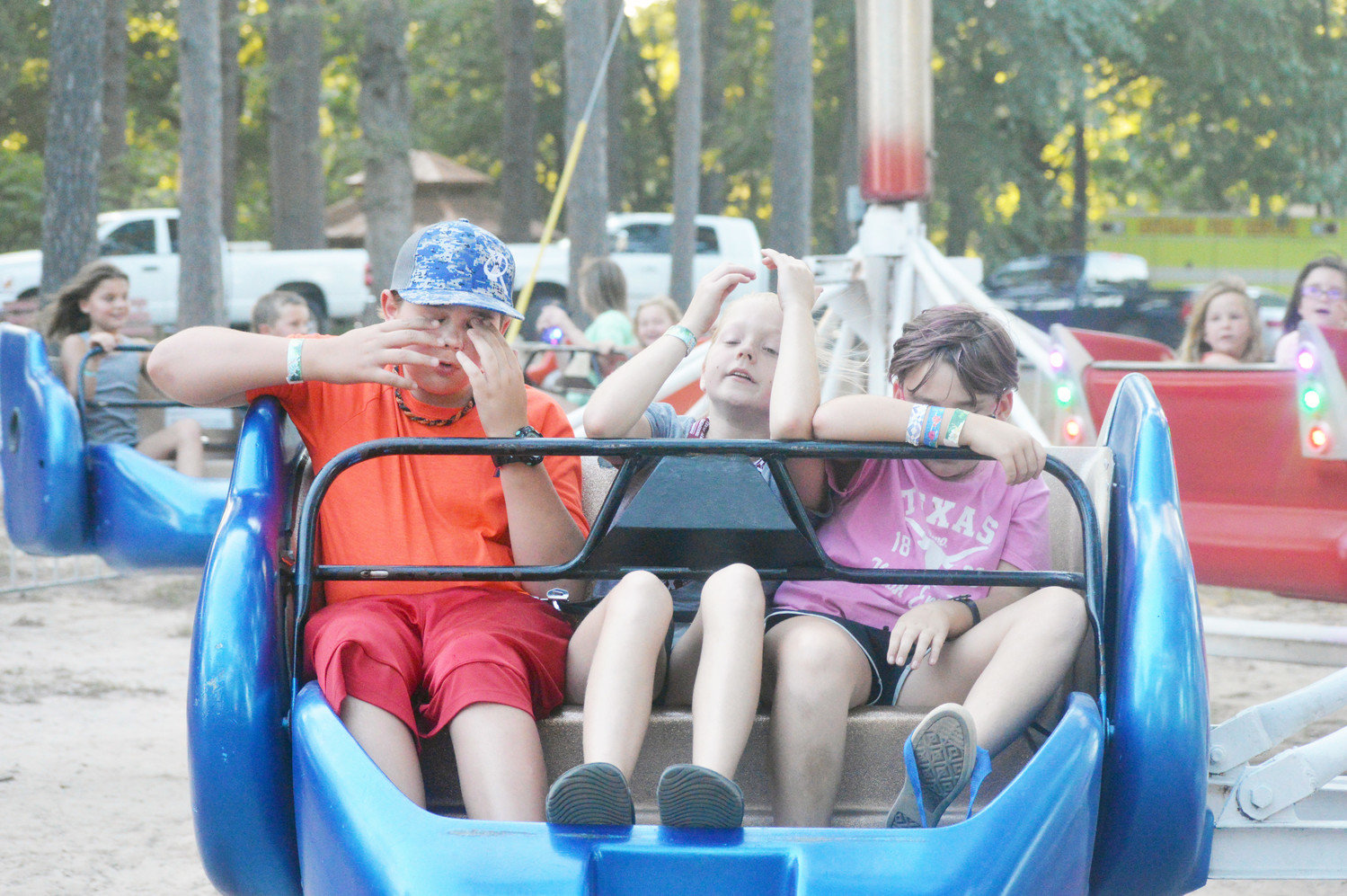 These three youngsters are ready for this ride to slow down so they can get off of it at the 116th Old Settlers Reunion at Jim Hogg City Park in Quitman last week.