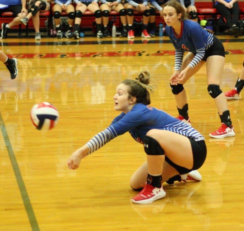 Lady Bulldog Lucy Brannon is focused like a laser on digging the ball in action against Van.