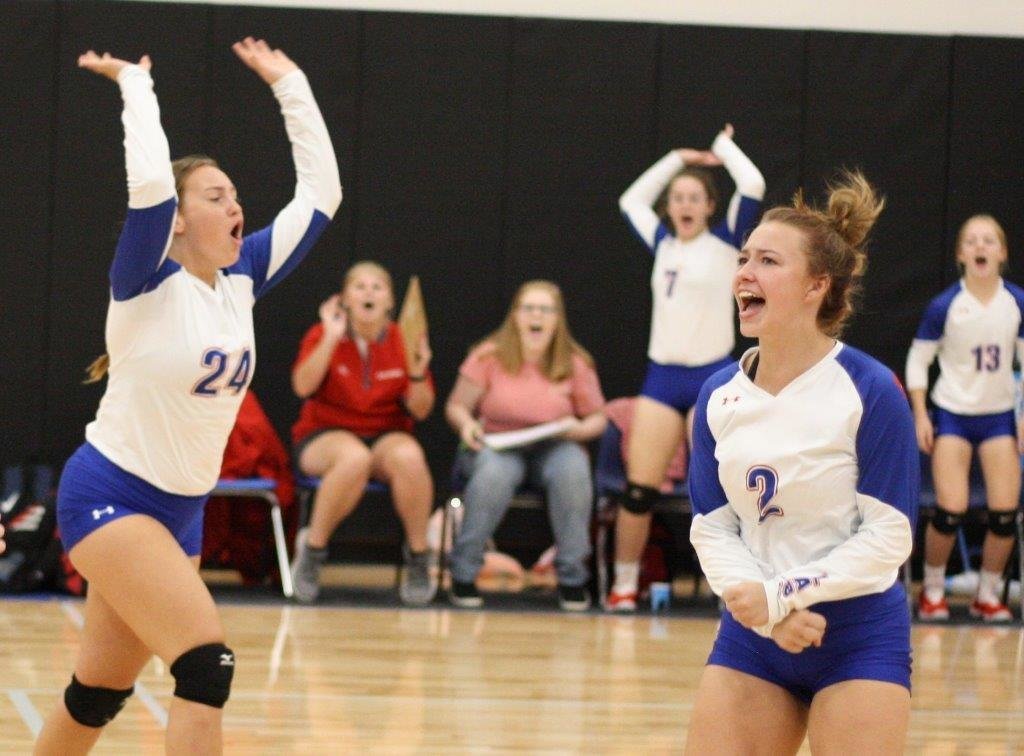 Lady Panthers Kayli Covey and Ann Marie Pendergrass celebrate winning a hard fought point against Longview.