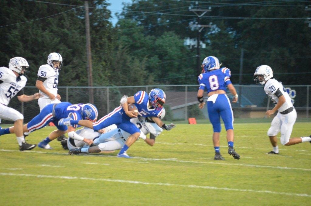 Quitman’s Ty Holland (5) stretches for more yardage in Friday’s game against Union Grove.