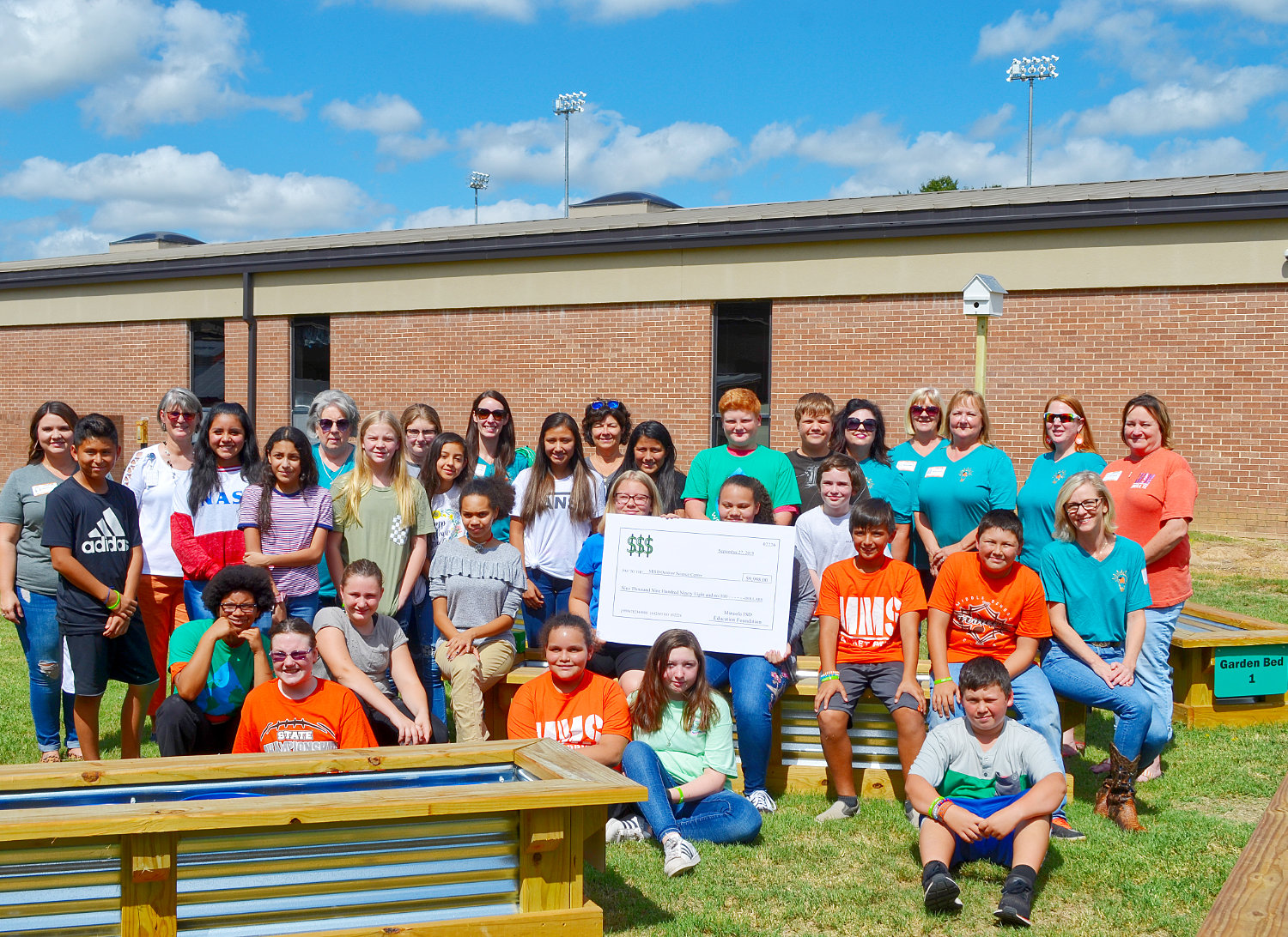 Mineola Middle School students celebrate their new outdoor science center which has benefited from numerous donations by individuals and companies.