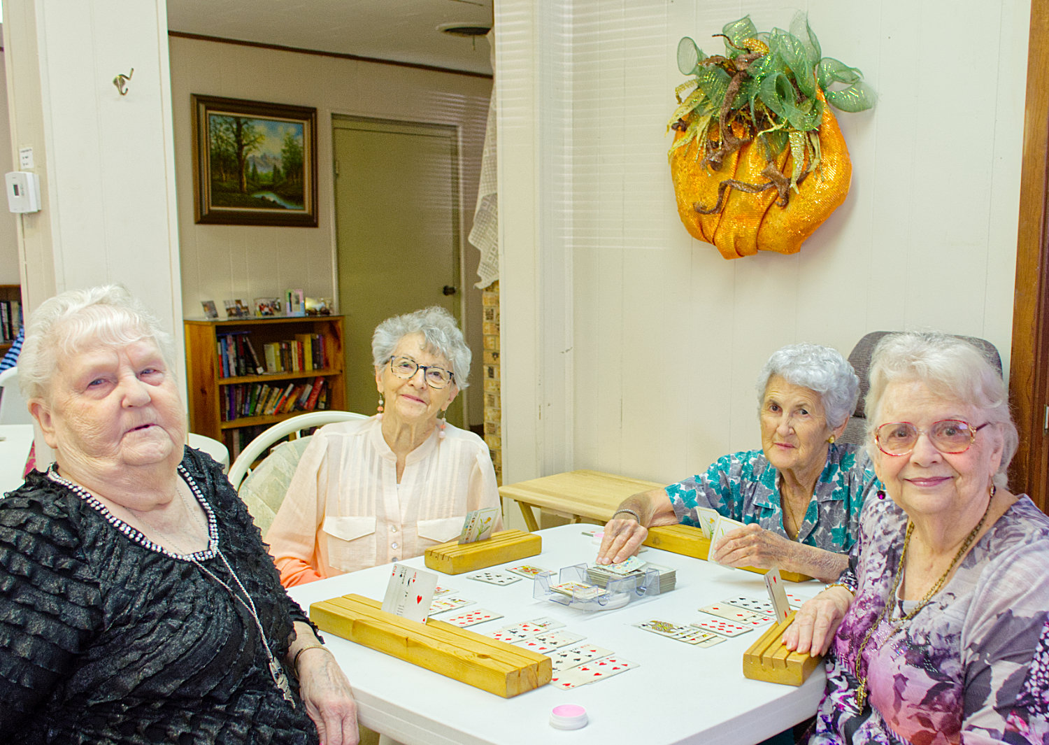 Ella Mae Clifton, (from left) Jeanette Treadaway, Sonja Vaughn and Linda Morgan meet at the Mineola Senior Citizen Center almost daily to play cards together. The center offers them fellowship and a place to connect.