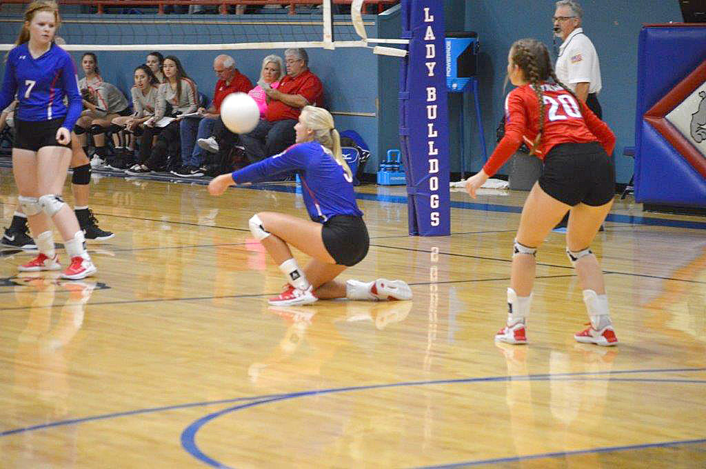 Quitman’s Julia Simpkins goes to the floor to dig out a Lone Oak serve in last Tuesday’s district win. (Monitor photo by Larry Tucker)
