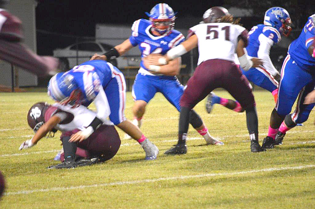 Chris Chabaud (34) breaks through the line for a nice run. He rushed for 100 yards in his first game for Quitman.