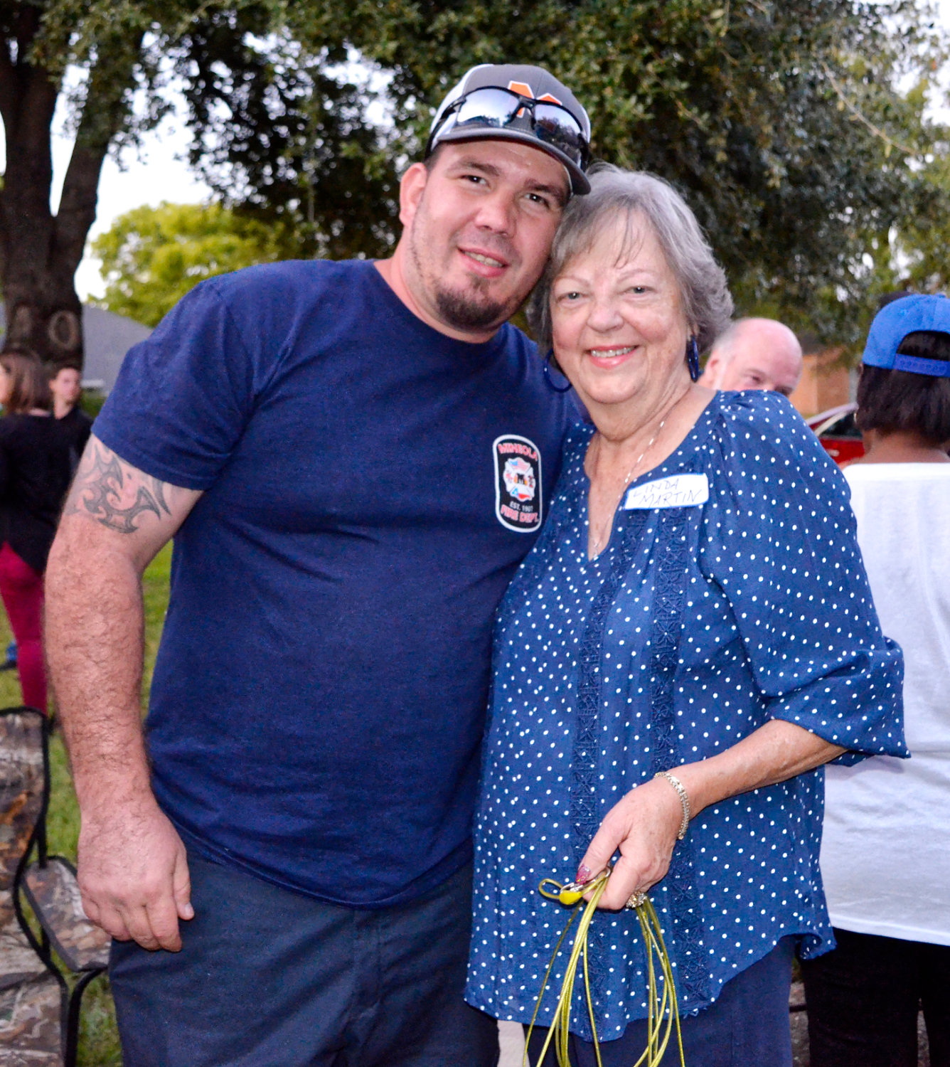 Linda Martin and firefighter Manny Morales enjoy the fellowship and food at her block party to bring the community and first responders together.