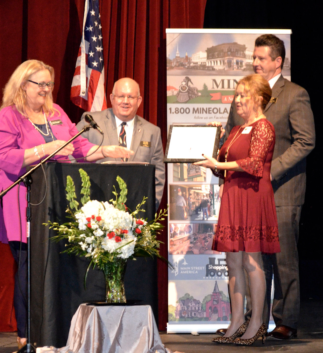 Debra Drescher, state coordinator of the Texas Main Street Program, presents recognition of Mineola’s 30 years in the program to Mayor Kevin White, Main Street Manager Doris Newman and Main Street Board President Jason Ray.