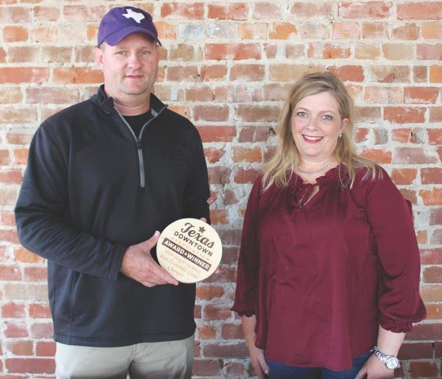 Jamie Wyatt of Colonial Construction and Denea Hudman, executive director of Quitman Development Corporation, are pictured with the Economic Game Changer Award received from the Texas Downtown Association Oct. 30.