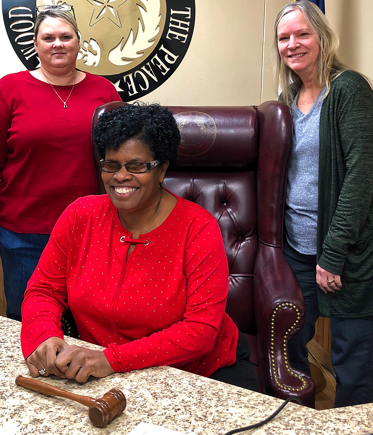 Justice of the Peace Janae Holland, seated, with staff members Monica Bailey and Anita Piper.