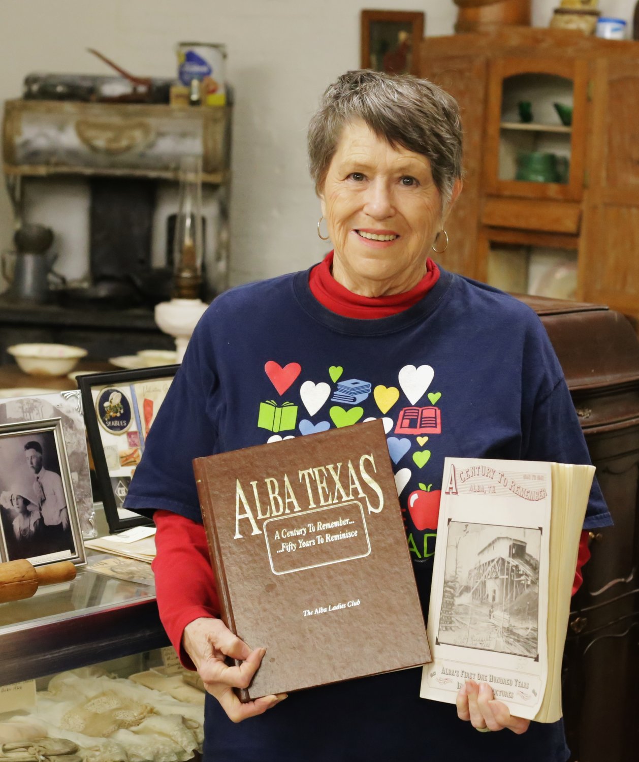 Local historian Saundra Burge holds the first two volumes of Alba History.