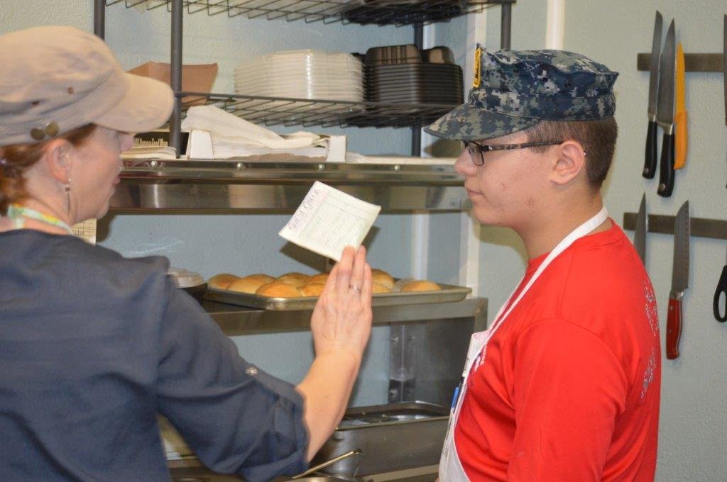Your Appetites owner Ingrid Hightower works with one of the Naval Sea Cadets on an order during the group’s training at the business.