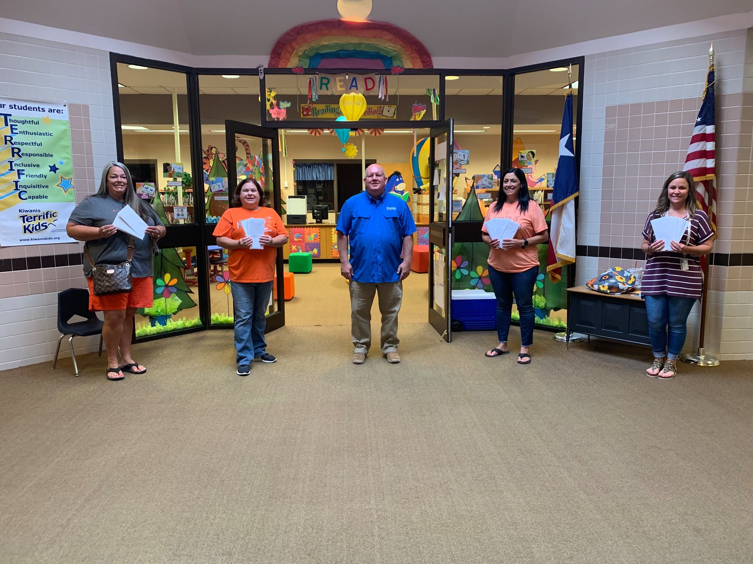 Mineola Primary School teachers, from left, Kathi Bruce - pre-K, Lori White - 2nd grade, Kevin White - Kiwanis Club president, Sylvia Harris - kindergarten, and Laura Harris - 1st grade receive their gift cards for schools supplies from the club. (Courtesy photo)