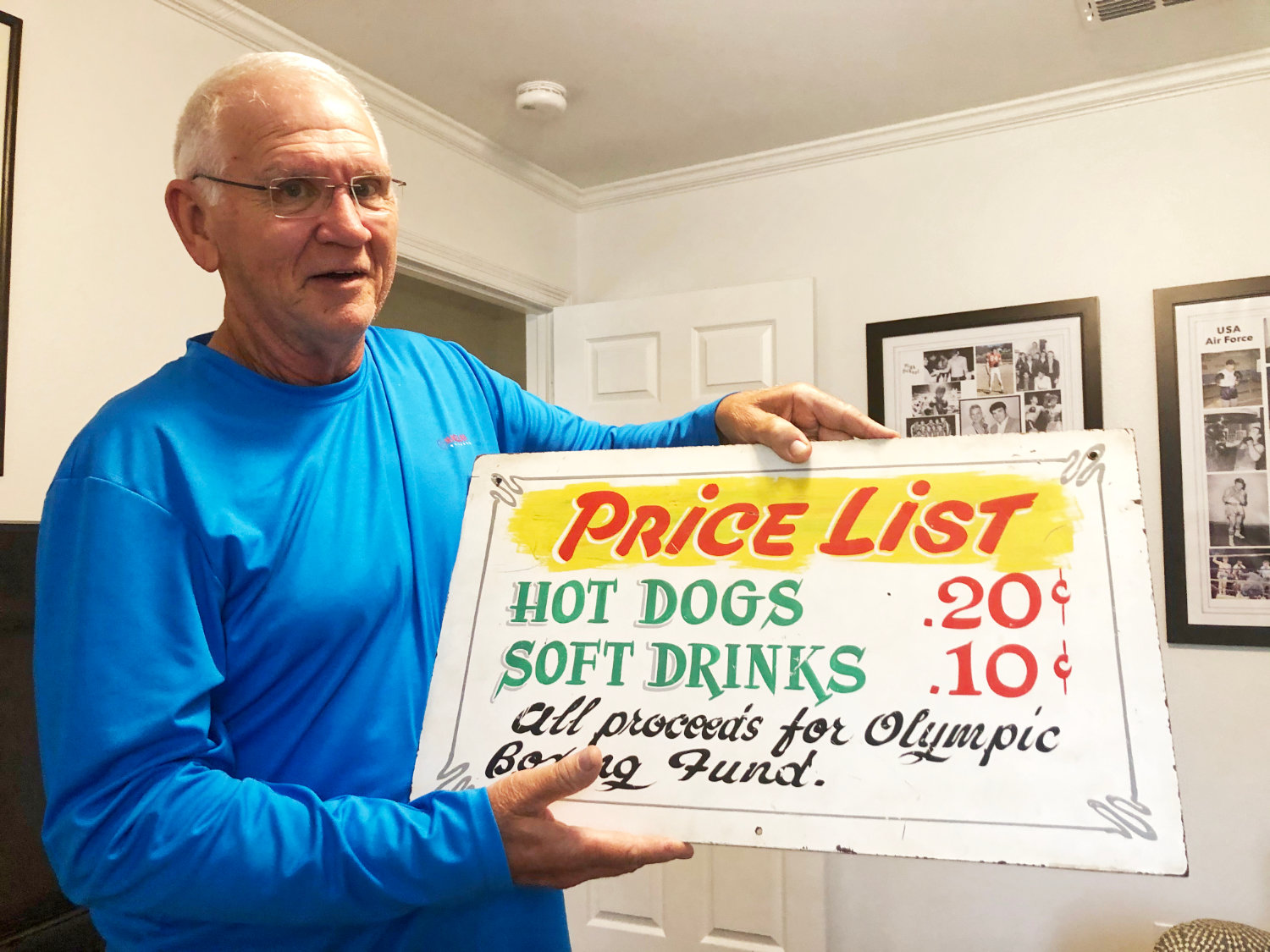 Nick Wells displays a sign from one of his days trying to make the United States Olympic team. It was a fundraiser for the Olympics in the early 1970s.