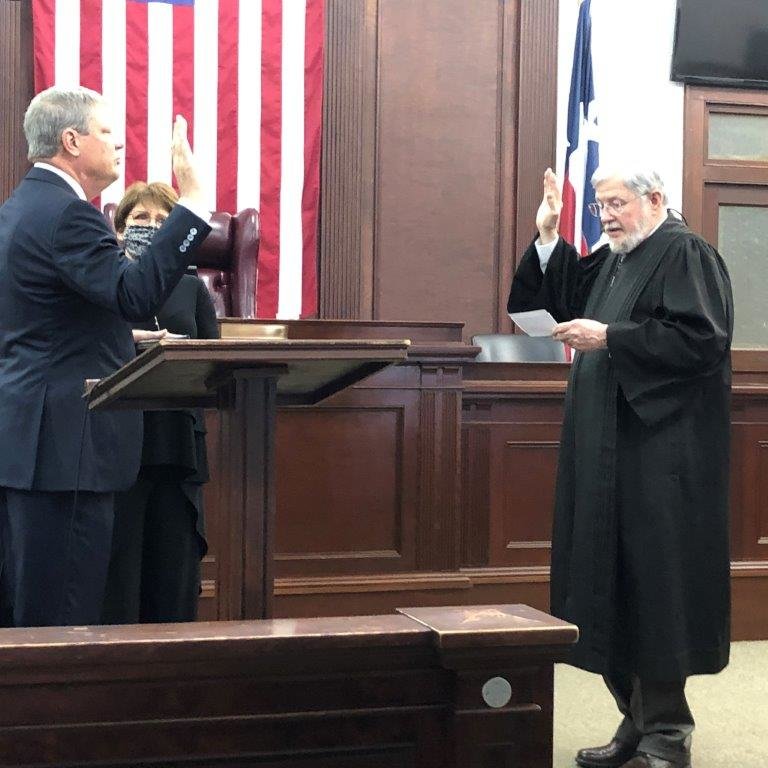 Brad McCampbell was sworn in as the new 402nd District Judge last Friday morning (Jan. 1) by the former judge Timothy Boswell as his wife Dawn McCampbell looks on.