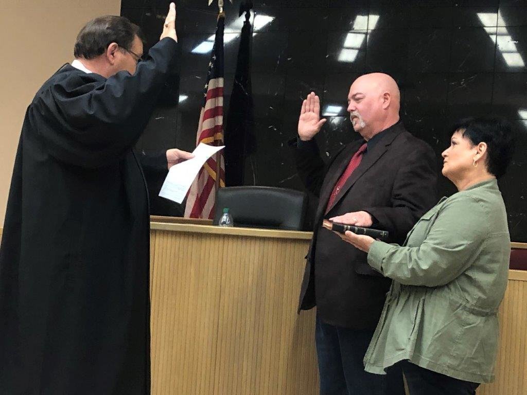 Justice of the Peace Precinct 1 Tony Gilbreath swears in new Wood County Sheriff Kelly Cole, who is pictured with his wife, Toni, at the ceremonies held at the Wood County Justice Center at 12:01 a.m. Friday, Jan. 1.