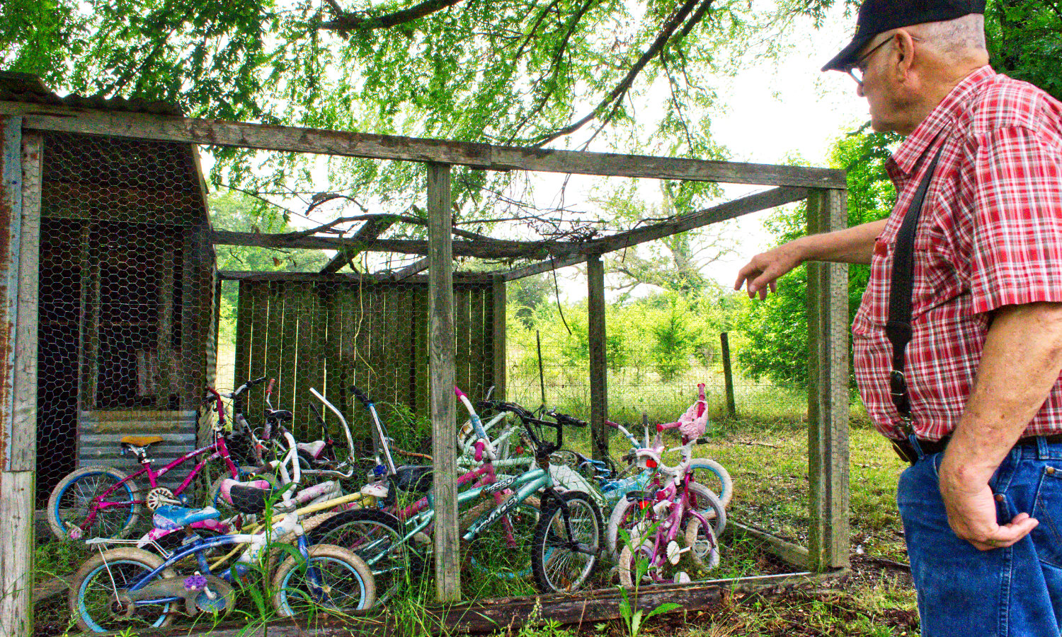 Robert Pierce looks over some of the bicycles he needs to clean and repair for children to enjoy.