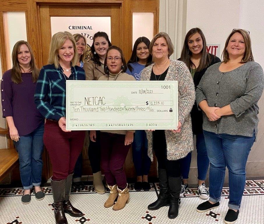 Wood County District Attorney Ange Albers and her staff are shown with a $10,223 check to be donated to the Northeast Texas Child Advocacy Center.