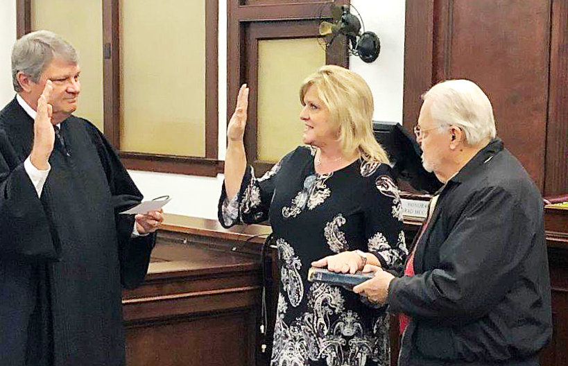 Suzy Wright was sworn in as the Wood County District Clerk Monday morning by District Judge Brad McCampbell (left). Former Wood County District Attorney Mark Taylor (right) is holding the Bible for the ceremony. Wright replaces Donna Huston who resigned the post effective Dec. 31, with a year left in her term. Wright is running unopposed for the position in the March Republican primary and in the November general election.