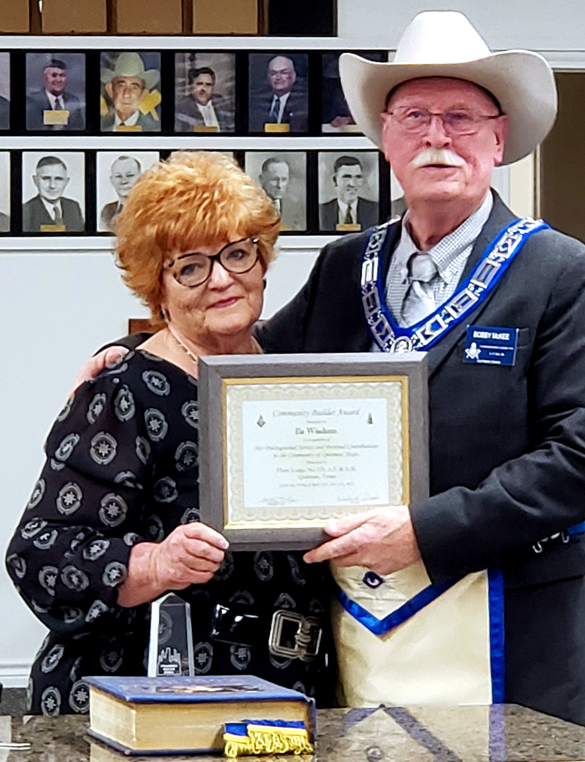 Ila Wisdom is presented the Community Builder Award by Bobby McKee with the Flora Masonic Lodge.