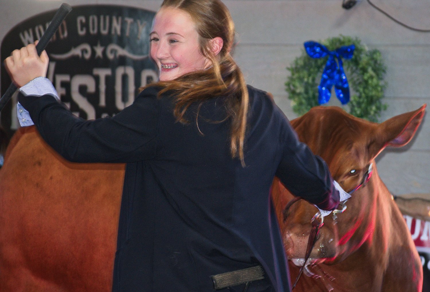 Kori Hammond and her grand champion steer in the auction ring Friday at Quitman High School to conclude the 2023 Wood County Junior Livestock Show.