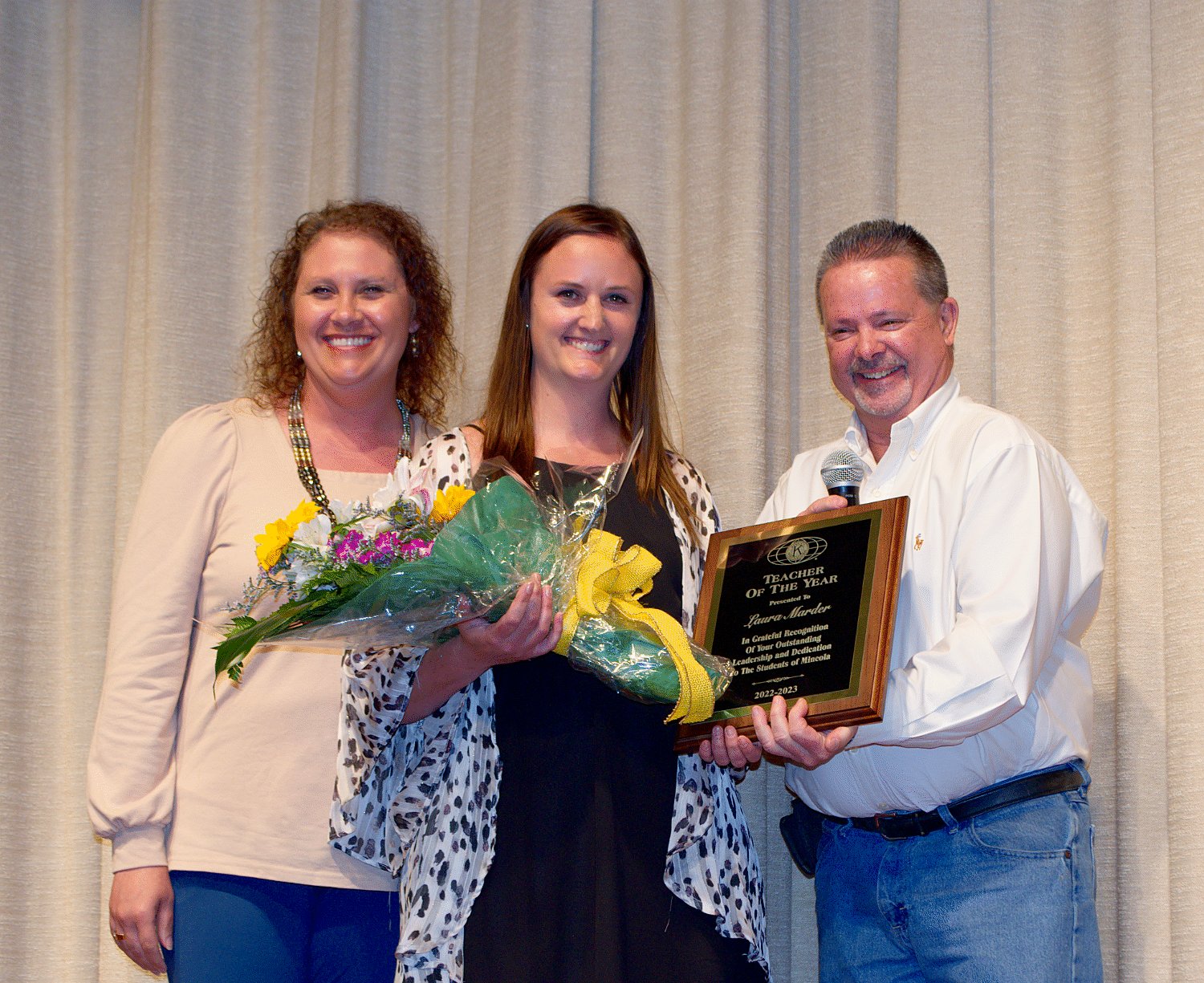 Laura Marder was named Mineola ISD teacher of the year, presented by members of the Mineola Kiwanis Club Amy Castleberry, left, and Brian Jones.