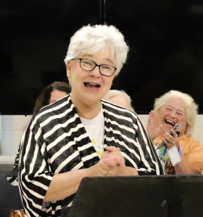 Alba-Golden first-grade teacher Vicki Walker reacts to the news that the annual Elementary School Field Day will now carry her name.
