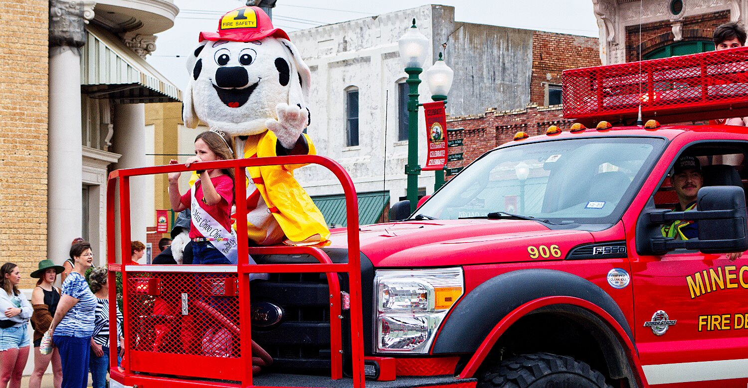 Lolo Clower of the Little Miss Choo Choo court holds steady at the front of the firetruck. [see so many more sesquicentennial spring fling photos]